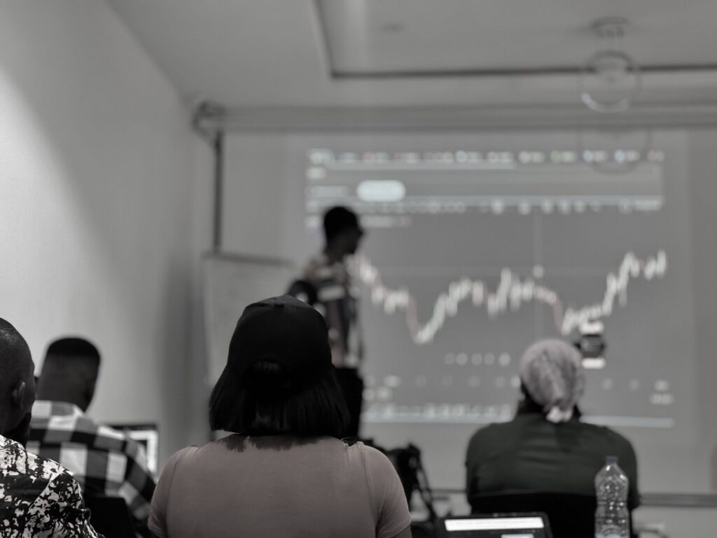 ESTT learners studying live Forex charts with the educator